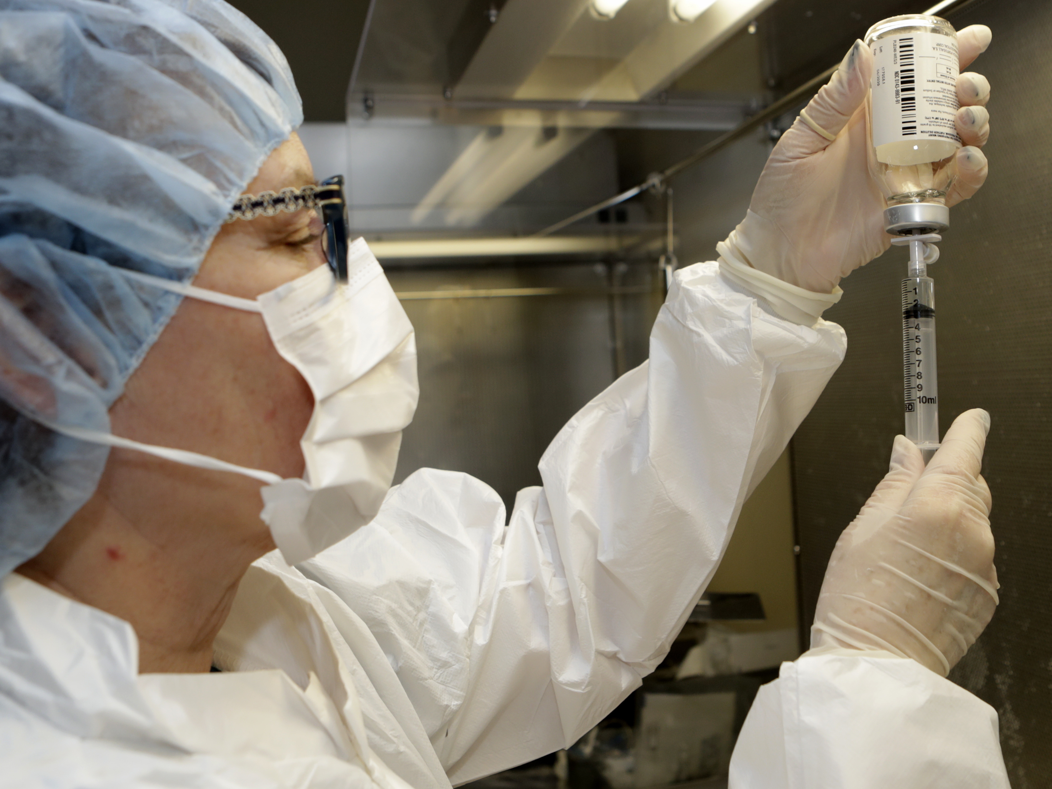 caption: Pharmacy technician Peggy Gillespie fills a syringe with an antibiotic at ProMedica Toledo Hospital in Toledo, Ohio, in January.