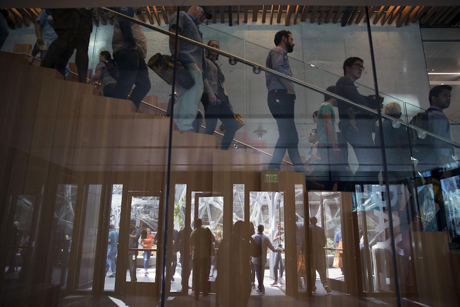 caption: Employees walking in Amazon's Seattle headquarters.