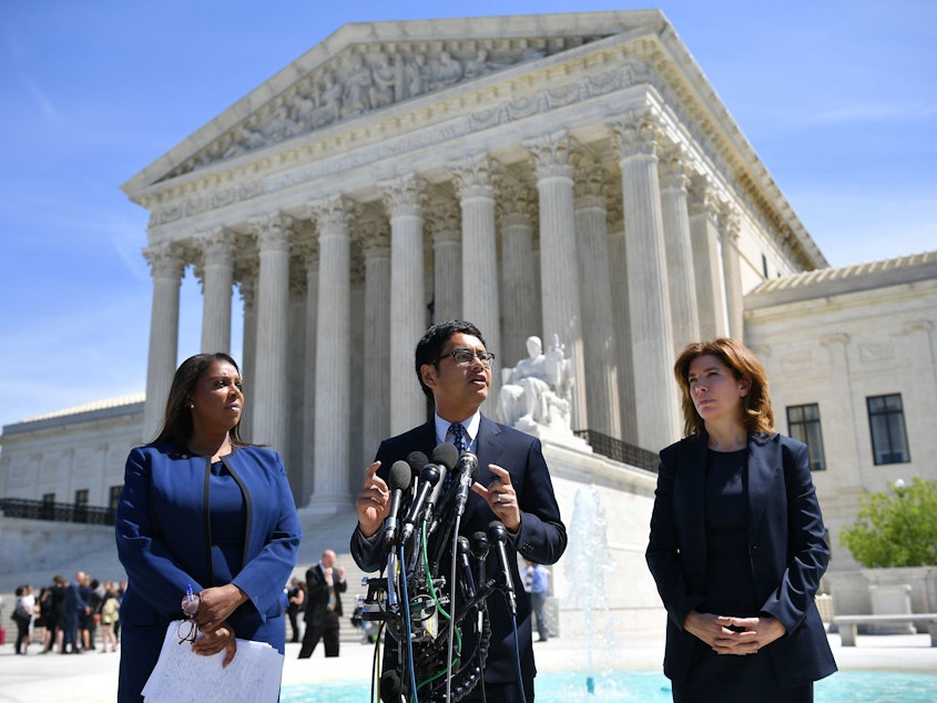caption: ACLU's Voting Rights Project Director Dale Ho (center) speaks outside the U.S. Supreme Court in April after arguing on behalf of plaintiffs in the lawsuits over the citizenship question the Trump administration wants to add to the 2020 census.