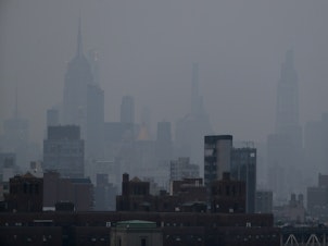 caption: A thick haze hangs over Manhattan on Tuesday. Wildfires in the West, including the Bootleg Fire in Oregon, are creating hazy skies and poor air quality as far away as the East Coast.