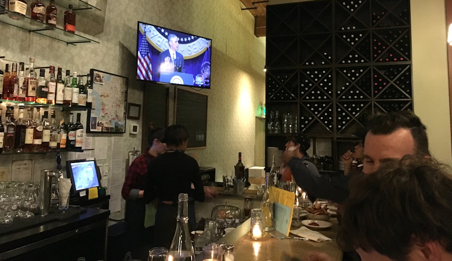 caption: President Barack Obama's farewell address plays on the TV at Cafe Presse.