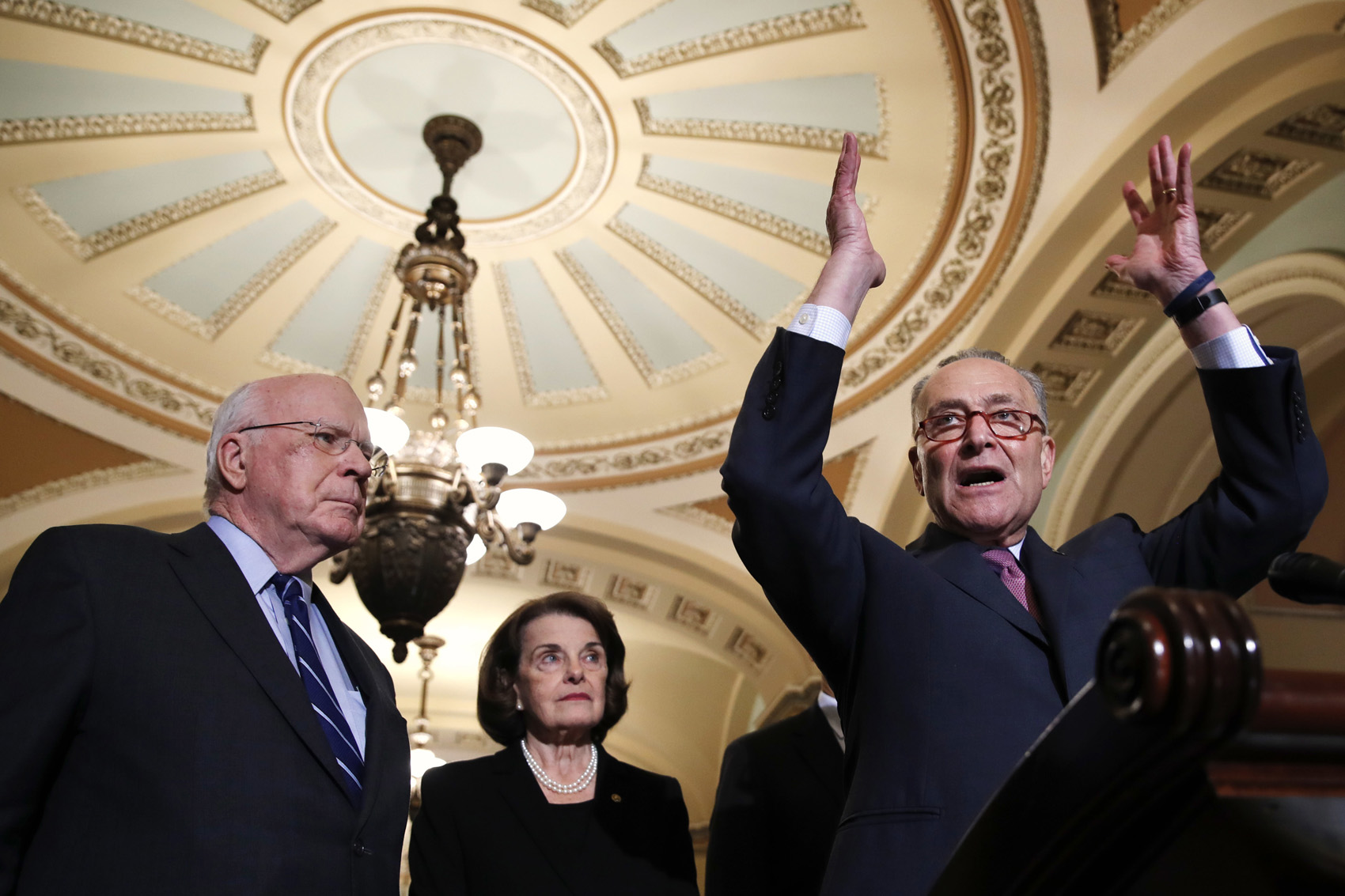 caption: Sen. Patrick Leahy, D-Vt., left, and Sen. Dianne Feinstein, D-Calif., listen as Senate Minority Leader Chuck Schumer of N.Y., speaks to the media after a Democratic policy luncheon, Tuesday, Nov. 27, 2018, on Capitol Hill. (Jacquelyn Martin/AP)