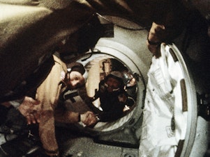 caption: Astronaut Tom Stafford (left) and cosmonaut Alexey Leonov shake hands after the first docking of U.S. and Soviet spacecraft in 1975.
