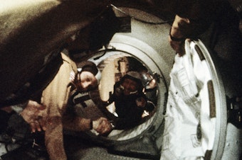 caption: Astronaut Tom Stafford (left) and cosmonaut Alexey Leonov shake hands after the first docking of U.S. and Soviet spacecraft in 1975.