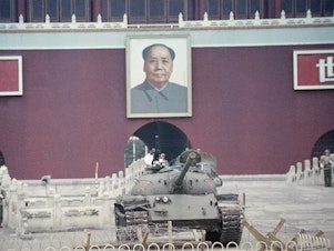 caption: A People's Liberation Army tank sits below a portrait of Mao Zedong at the Gate of Heavenly Peace in Beijing on June 11, 1989, one week after the crackdown on protesters at Tiananmen Square.