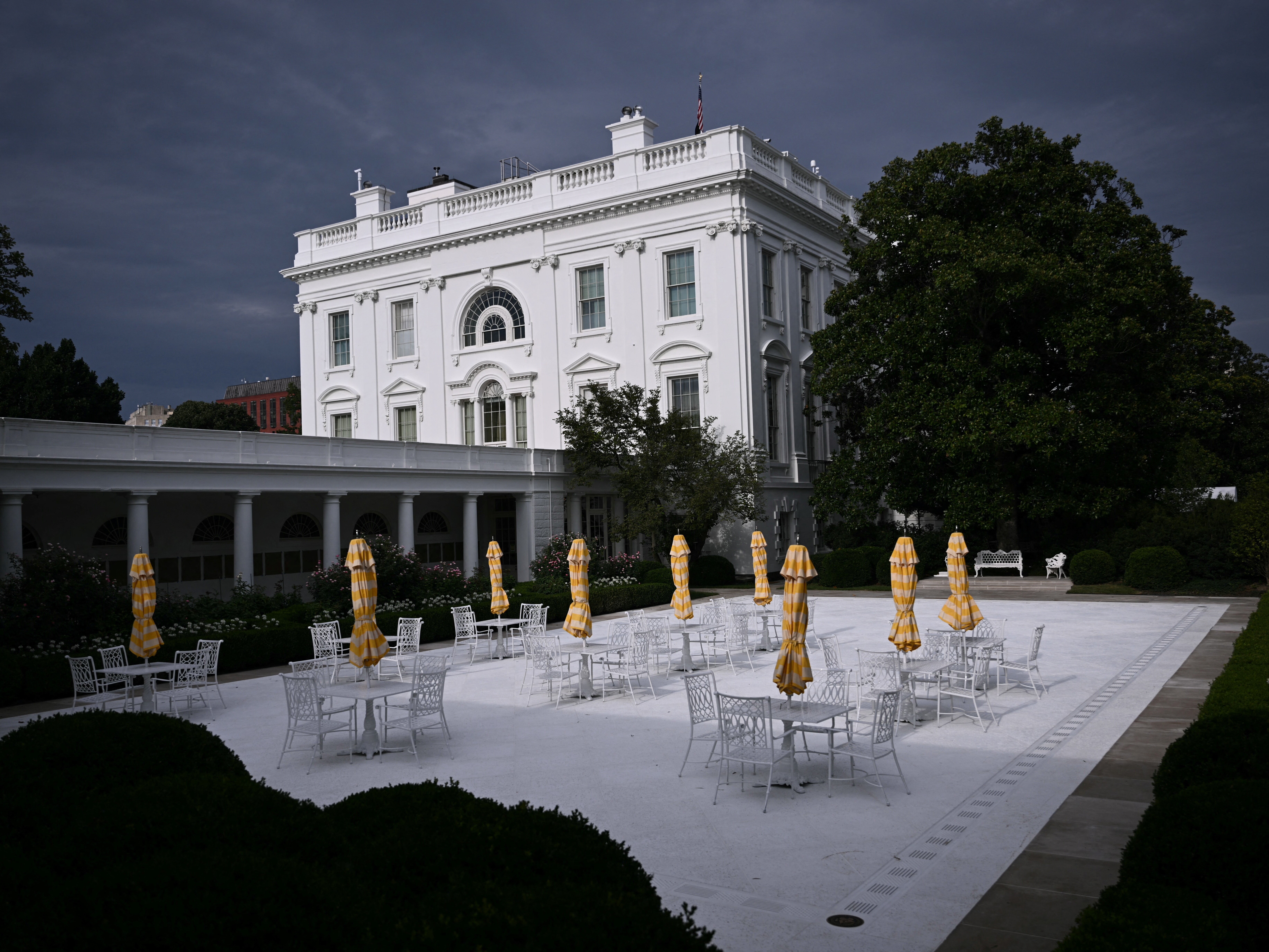 caption: A view of the newly paved Rose Garden is seen at the White House in Washington, DC, on August 6, 2025. US President Donald Trump converted the grass portion of the Rose Garden into a patio space, inspired by his Mar-a-Lago club in Florida.