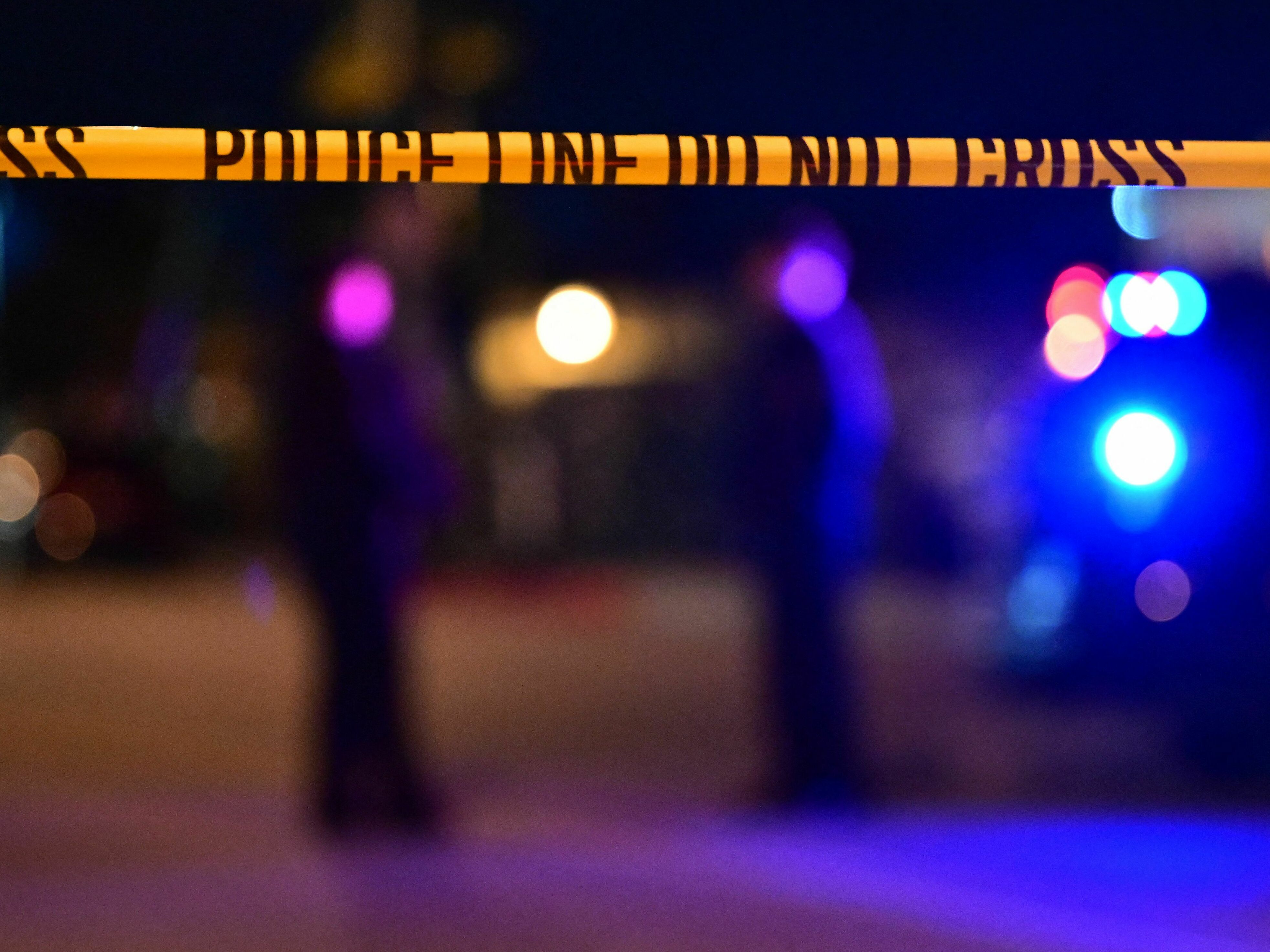 caption: Police tape is pictured at a crime scene in Monterey Park, Calif., in January 2023.