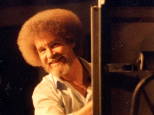 caption: Bob Ross hosted <em>The Joy of Painting </em>for 31 seasons in the 1980s and '90s. He died in 1995. The painter is now the subject of a new documentary,<em> Bob Ross: Happy Accidents, Betrayal & Greed.</em>