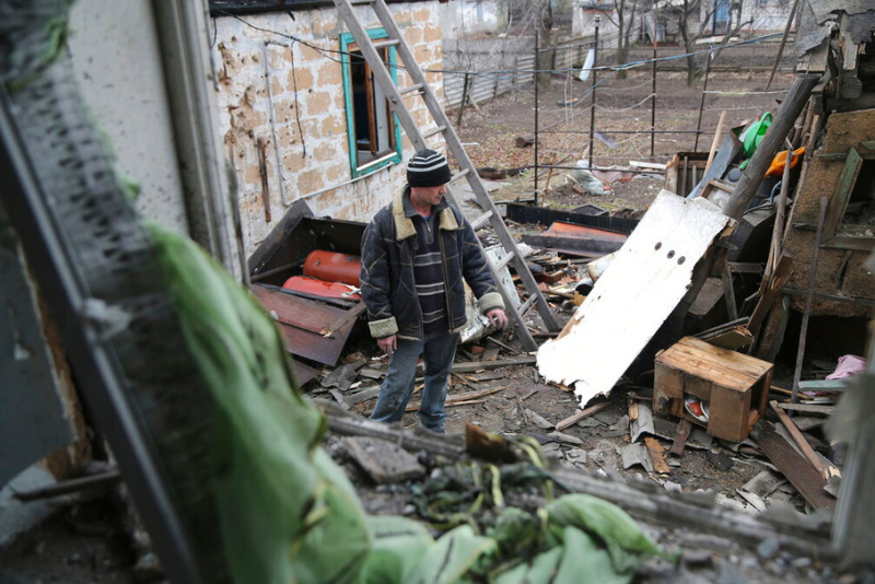 caption: A local citizen stands between debris of his house following Ukrainian shelling in the territory controlled by pro-Russian militants, eastern Ukraine, Thursday, Feb. 24, 2022. Russian troops have launched a three-pronged assault on Ukraine that opened with air and missile strikes on Ukrainian military facilities and included ground troops invading from Crimea.