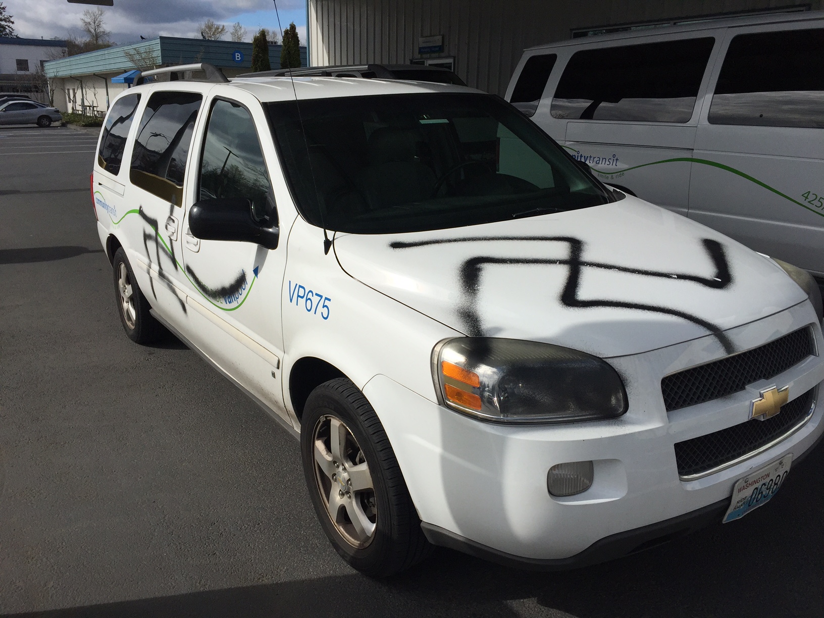 caption: This Vanpool vehicle, returned to Community Transit's headquarters for cleaning, was one of many cars tagged with swastikas. It is driven by KUOW employee Bond Huberman. 