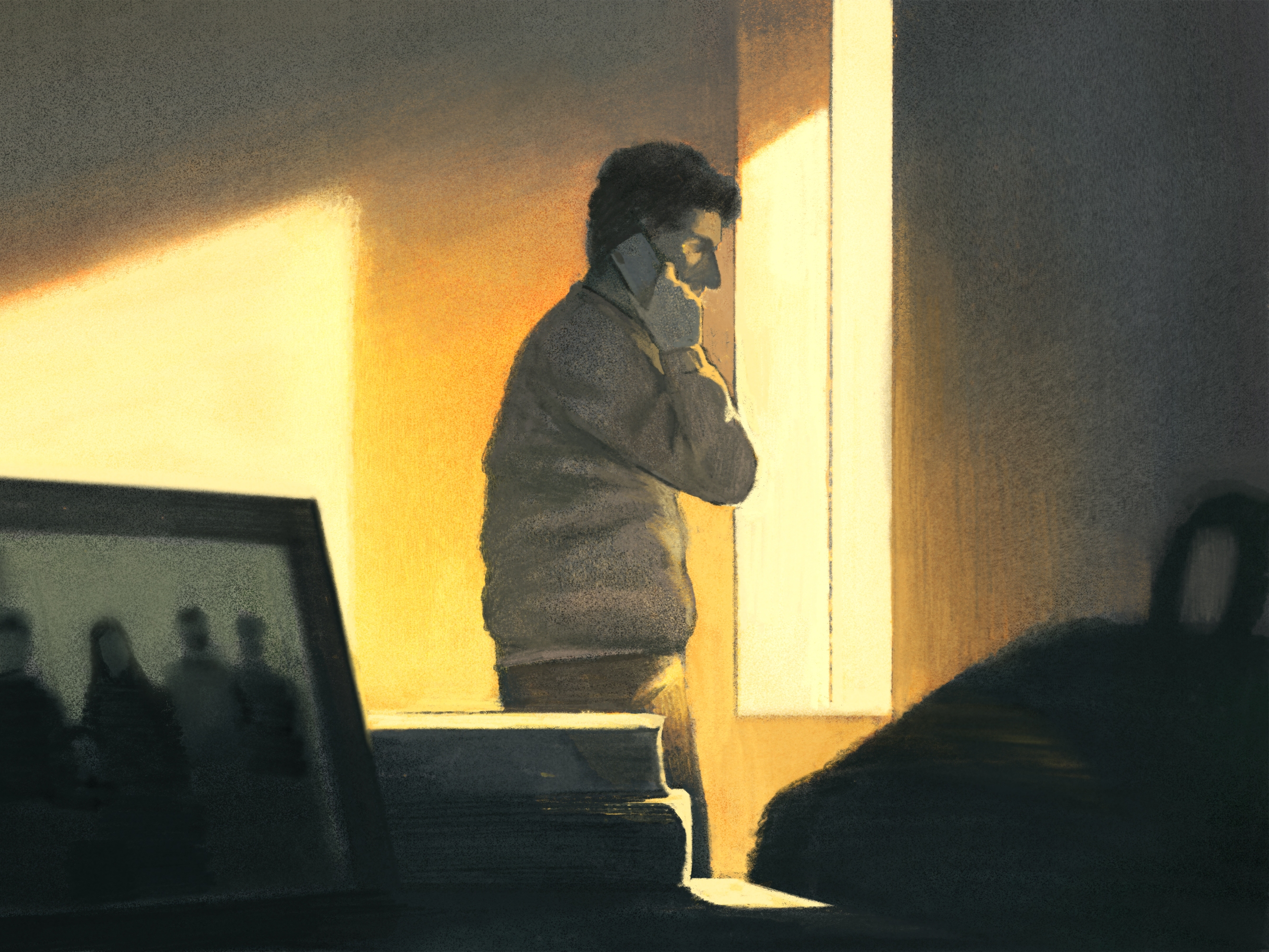 caption: BH talking to his family through the phone in the background and photos of the family in the foreground.