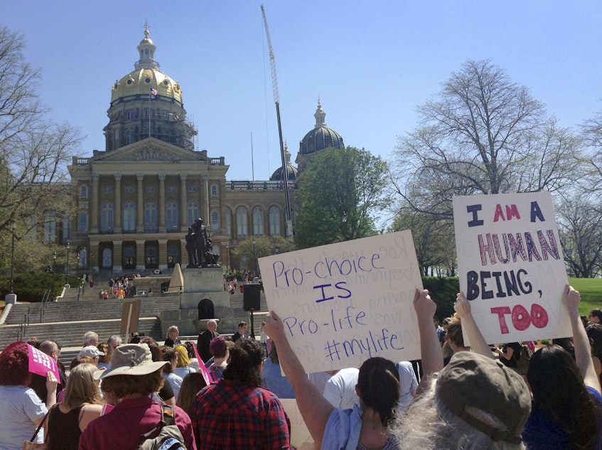 caption: Abortion rights advocates rally outside the Iowa Capitol Building in May. A law there banning abortion after a fetal heartbeat is detected is one of several state laws its way through the courts.