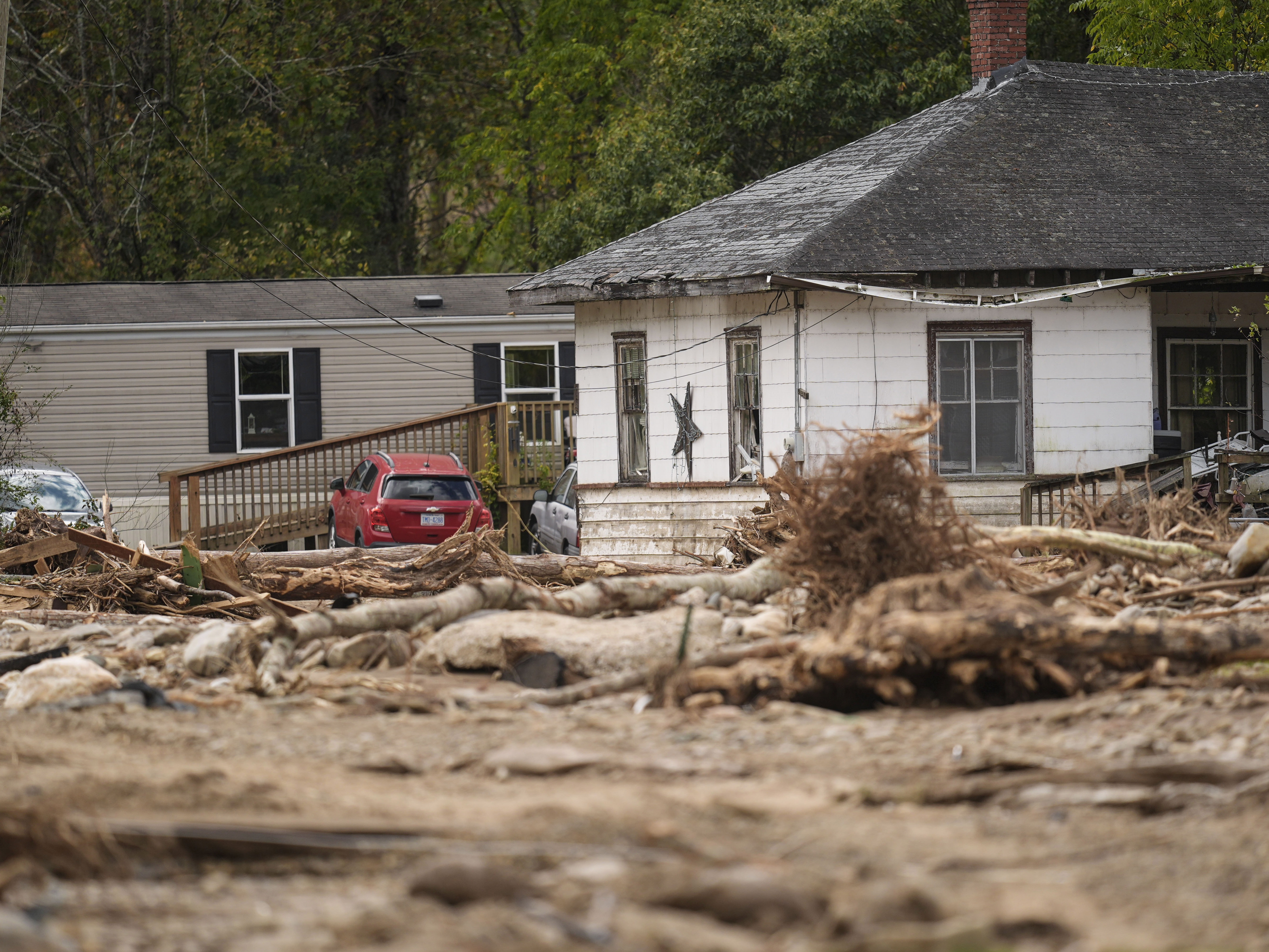 caption: Homes lie in a debris field in the aftermath of Hurricane Helene, Thursday, Oct. 3, 2024, in Pensacola, N.C.