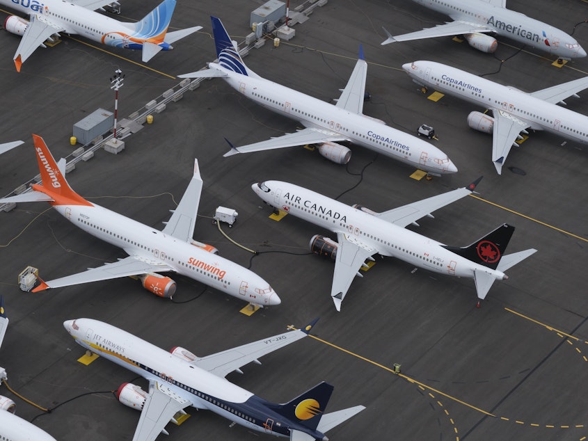 caption: Boeing 737 Max airplanes are stored in an area adjacent to Boeing Field, on June 27, in Seattle. Airlines around the world are cutting flights because of the grounding of the plane.