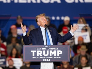 caption: Republican presidential candidate former President Donald Trump delivers remarks during a campaign event on November 11, 2023 in Claremont, New Hampshire.