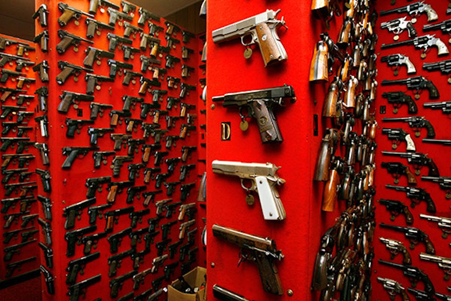 caption: Guns line the walls of the firearms reference collection at the Washington Metropolitan Police Department headquarters in Washington, D.C.