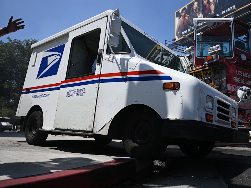 caption: The U.S Postal Service is planning to implement temporary price increases for the upcoming 2022 holiday season. The agency said it will help keep them competitive and cover increased costs for the season.