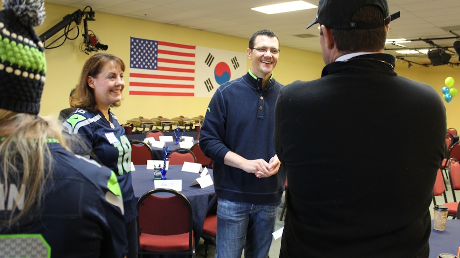 caption: State Sen. Joe Fain (R-Auburn), center, greets supporters at a breakfast campaign event with state Sen. Ann Rivers (R-La Center), left, on Oct. 14, 2018.