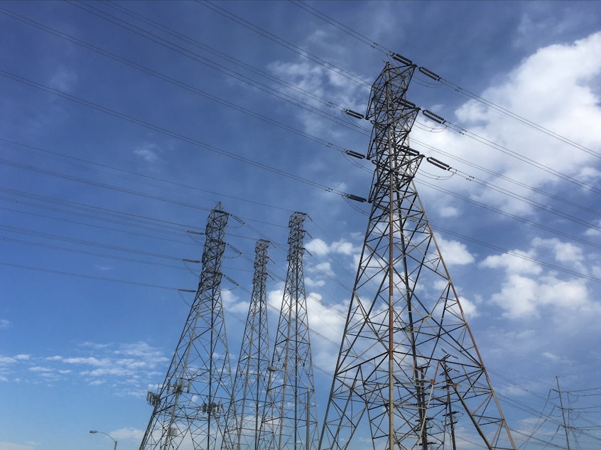 caption: Electrical grid transmission towers in Pasadena, Calif. Major power outages from extreme weather have risen dramatically in the past two decades.