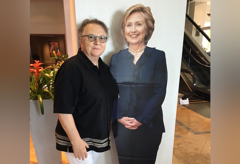 caption: Susan Atlas poses with a cutout of Hillary Clinton at a hotel lobby in Philadelphia on Friday.