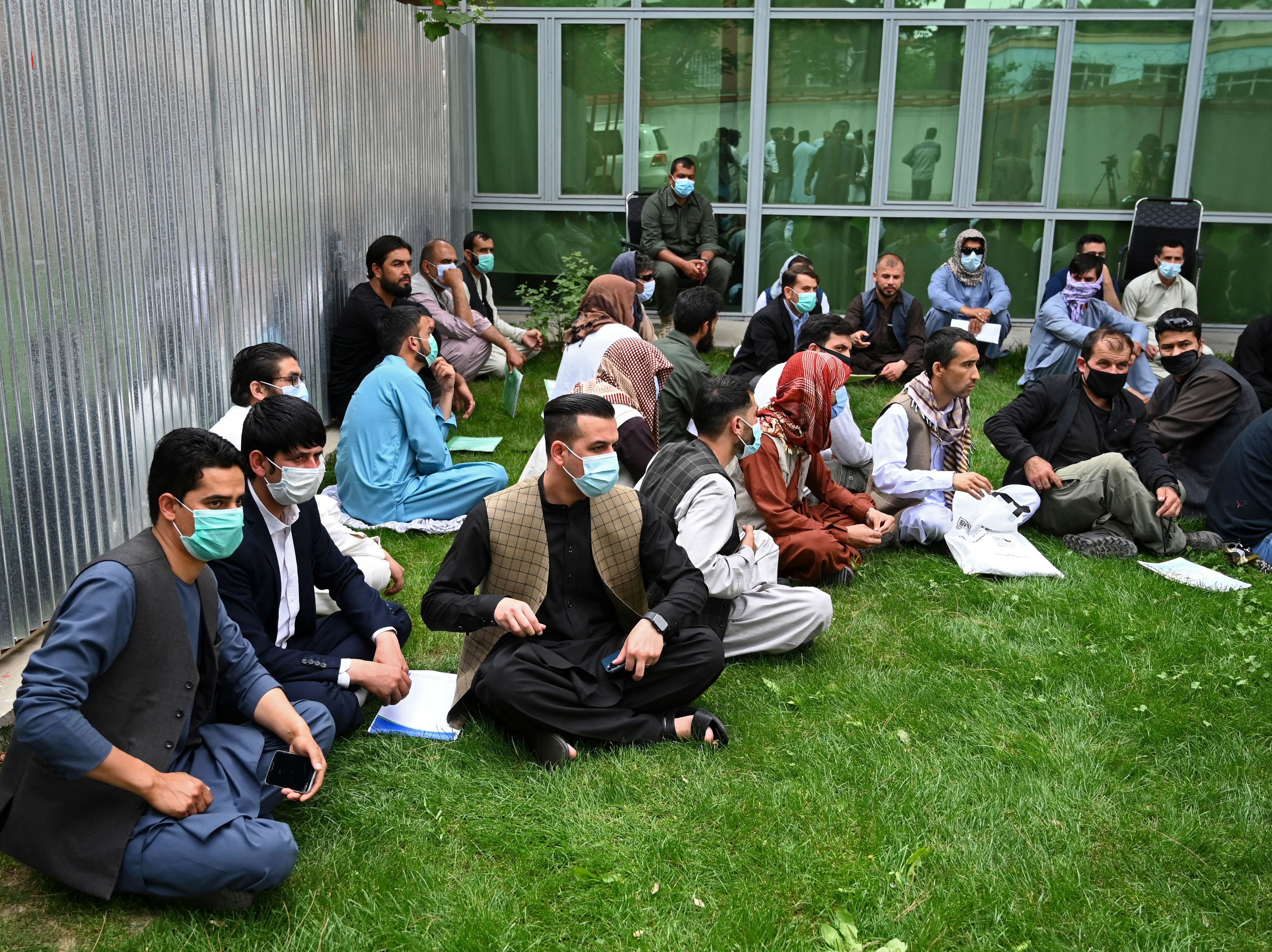 caption: Former interpreters for U.S. and NATO forces gather during a demonstration in downtown Kabul, Afghanistan, on April 30, on the eve of the beginning of Washington's troop withdrawal.