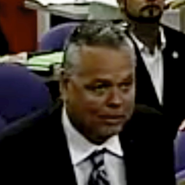 caption: In this 2015 photo, then-school resource officer Scot Peterson spoke at a school board meeting of Broward County in Florida. Peterson was arrested on Tuesday and faces 11 charges in the wake of the Marjory Stoneman Douglas High School shooting.