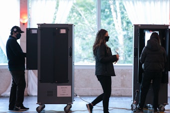 caption: Voters cast ballots at the Park Tavern polling station on Tuesday in Atlanta. Nearly 95% of Georgia's estimated ballots have been reported, but metro Atlanta is currently the holdout area.