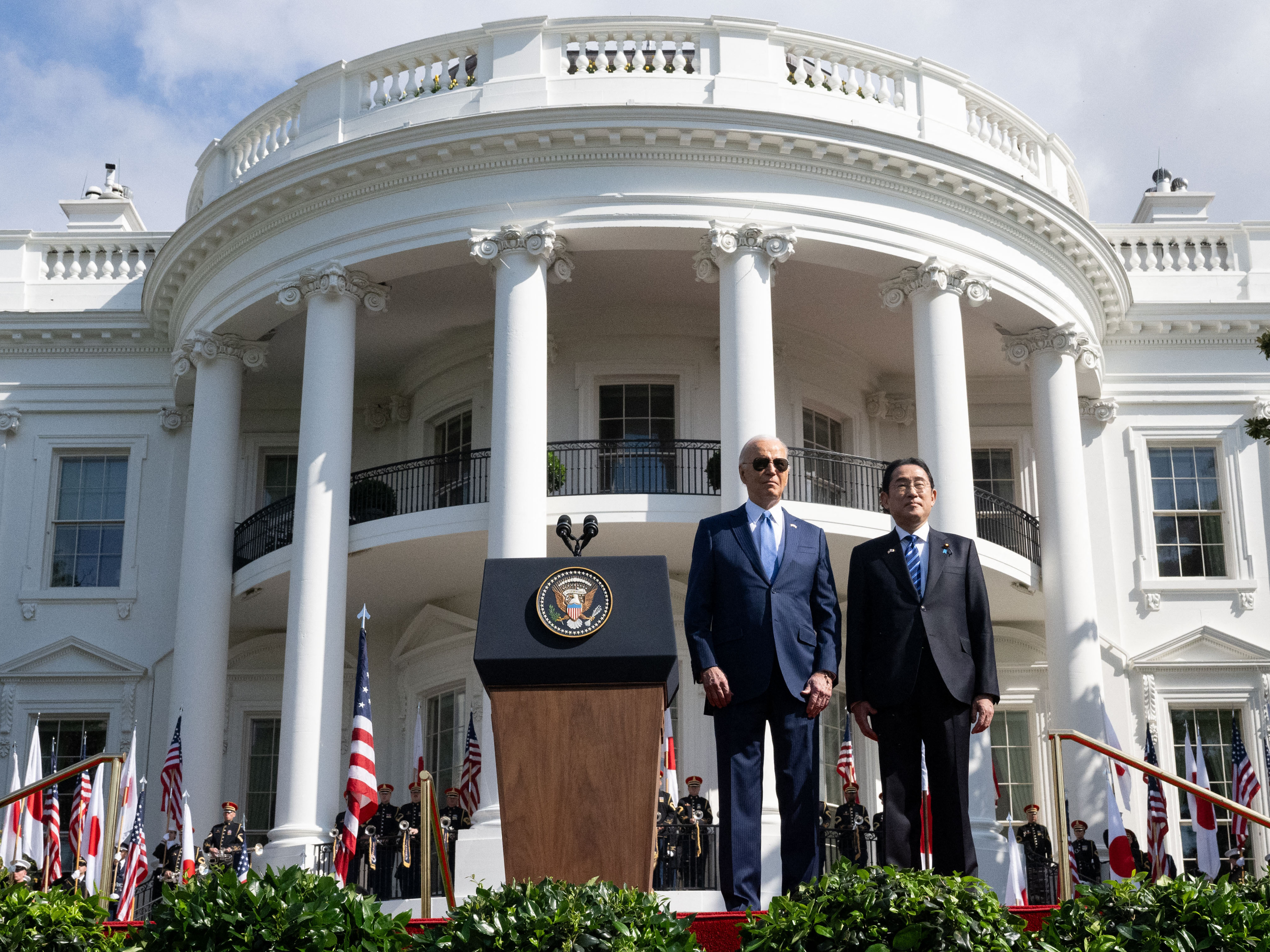 caption: President Biden and Japanese Prime Minister Fumio Kishida stand together during a state visit ceremony at the White House.