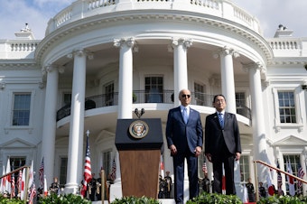 caption: President Biden and Japanese Prime Minister Fumio Kishida stand together during a state visit ceremony at the White House.