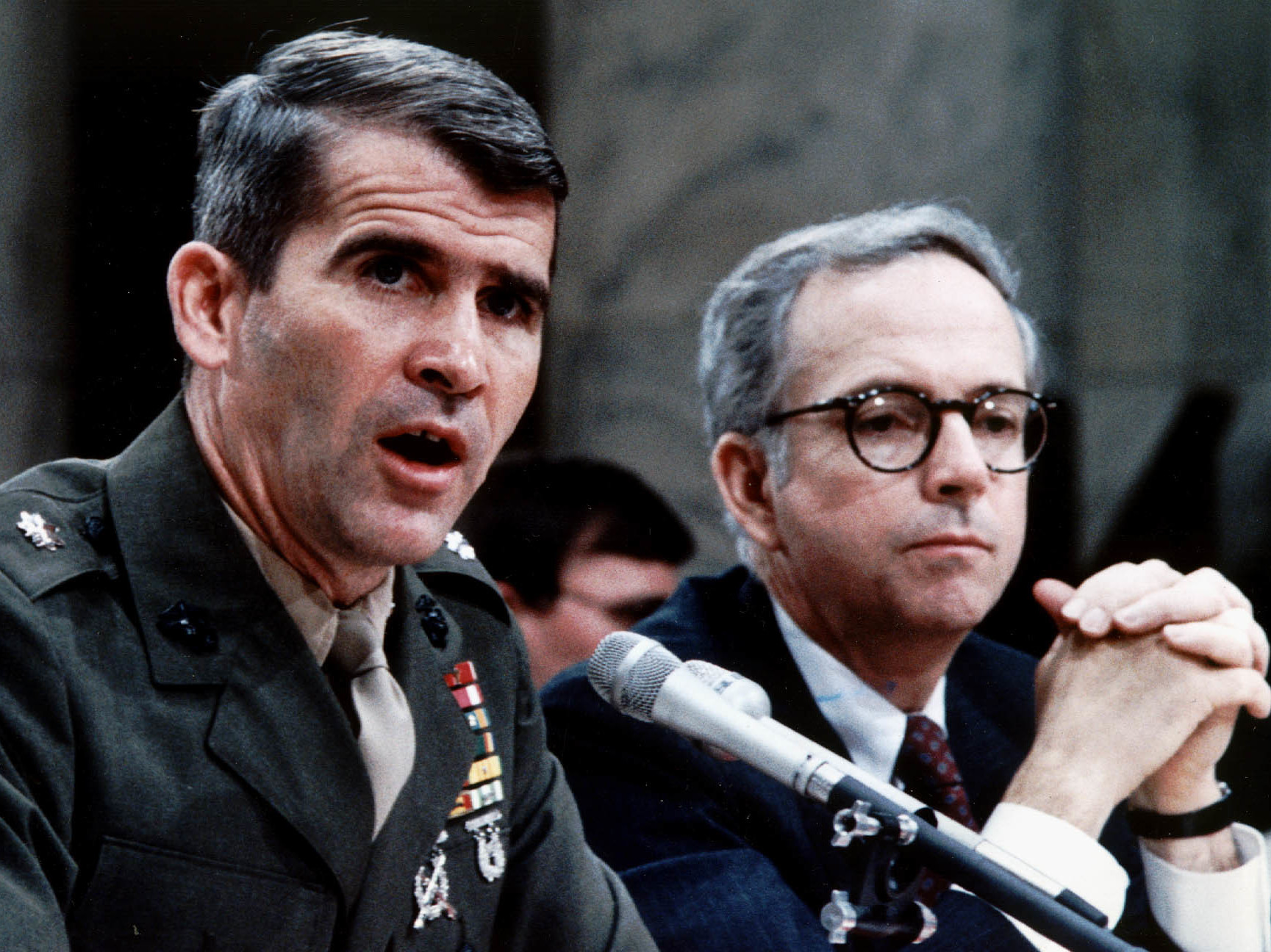 caption: Marine Corps Lt. Col. Oliver North, accompanied by his lawyer Brendan Sullivan, was a central figure in the Iran-Contra hearings.
