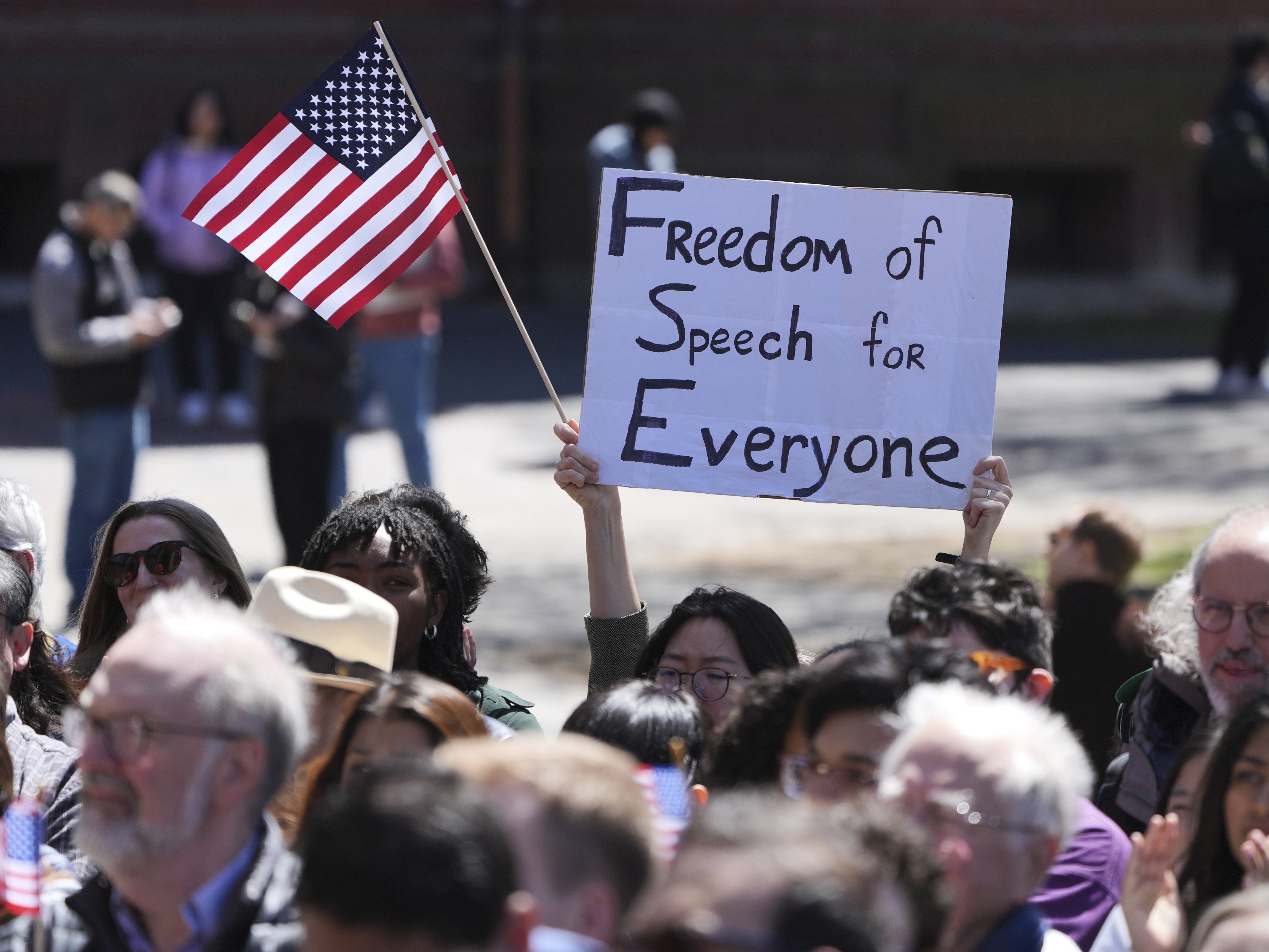 caption: Students, faculty and members of the Harvard University community rally, Thursday, April 17, 2025, in Cambridge, Mass.