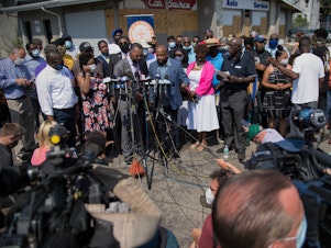 caption: The Rev. Jesse Jackson spoke at a press briefing Thursday in Kenosha, Wis., in the parking lot of Bert and Rudy's Auto Service, where two protesters were shot and killed Tuesday night.