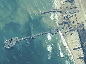 caption: The image provided by U.S, Central Command, shows U.S. Army soldiers, U.S. Navy sailors and Israel Defense Forces placing the Trident Pier on the coast of Gaza Strip on Thursday.