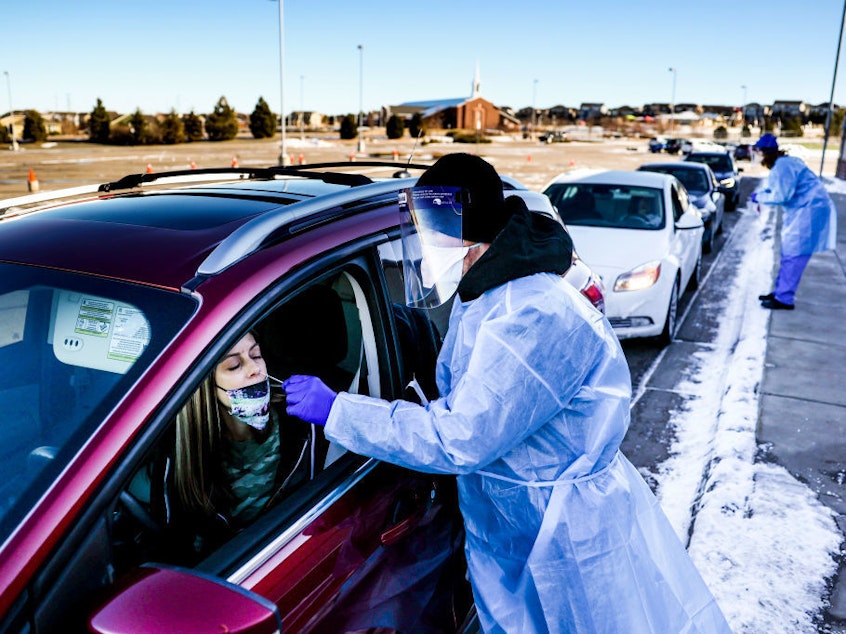 caption: A coronavirus variant that is thought to be more contagious was detected in the United States in Elbert County, Colo., not far from this testing site in Parker, Colo. The variant has been detected in several U.S. states.