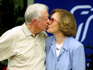 caption: Former U.S. president Jimmy Carter receives a kiss from his wife Rosalynn Carter after a press conference in Plains, Ga., in Oct. 2002.