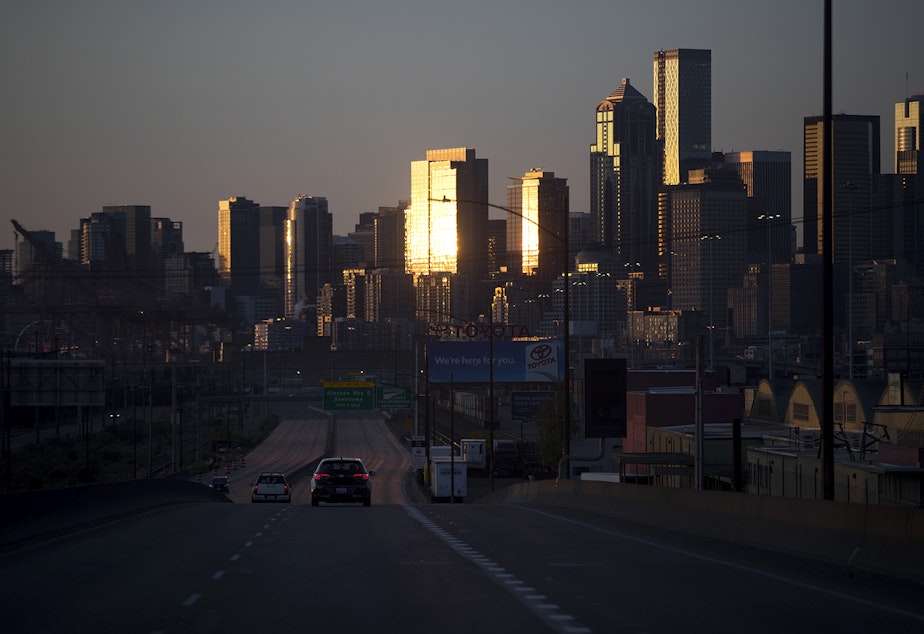 caption: The sun sets on downtown Seattle on Thursday, May 7, 2020.