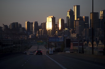 caption: The sun sets on downtown Seattle on Thursday, May 7, 2020.
