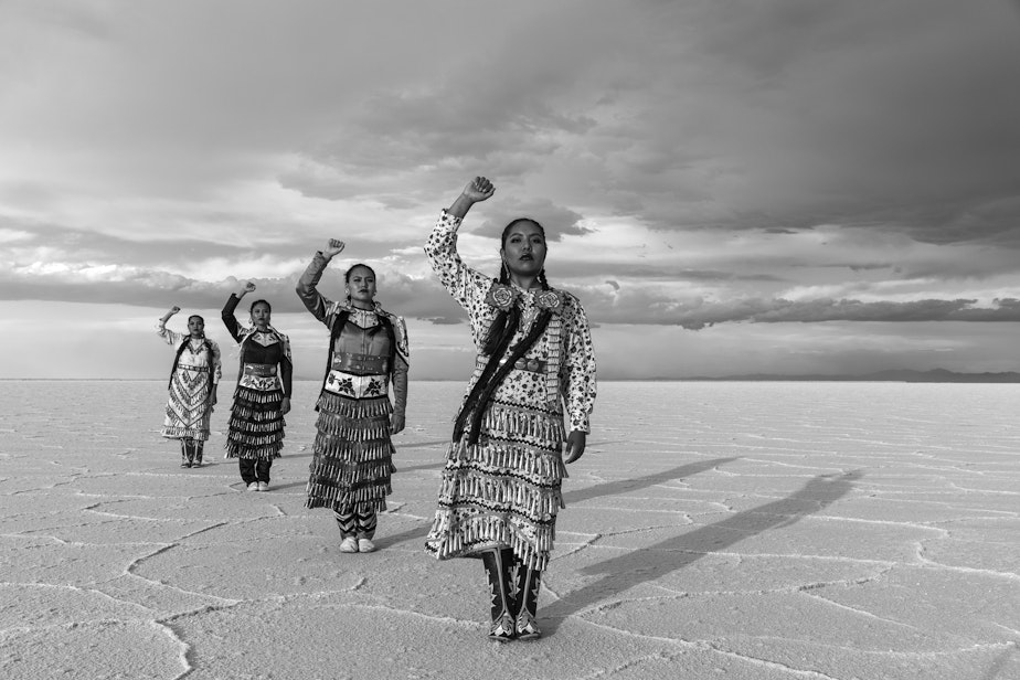caption: From front, Erin Tapahe, JoAnni and Sunni Begay and Dion Tapahe pose with their fists raised on the Bonneville Salt Flats in northwestern Utah.