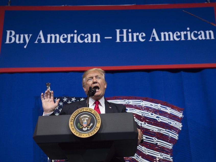 caption: President Trump speaks before signing the Buy American, Hire American Executive Order in April 2017 in Kenosha, Wis.