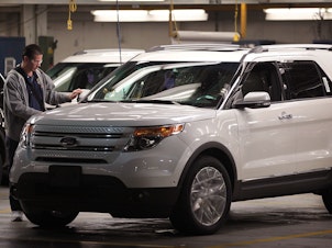 caption: A worker assembles a 2011 Ford Explorer at the Chicago Assembly Plant in 2010 in Chicago. Ford is recalling nearly 1.9 million Explorers in the 2011-2019 model years over a piece of trim that can detach from the vehicles.