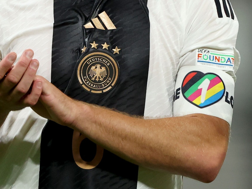 caption: The captain's armband, similar to this one, shown during a September game between Germany and Hungary. European national teams have told their captains not to wear it during the 2022 World Cup in Qatar.