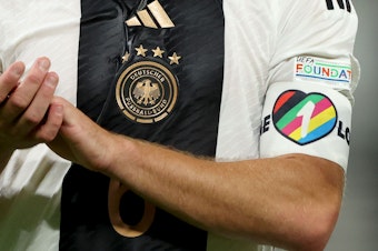 caption: The captain's armband, similar to this one, shown during a September game between Germany and Hungary. European national teams have told their captains not to wear it during the 2022 World Cup in Qatar.