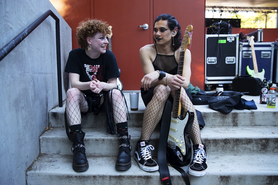 caption: Cass, left, and Sam, of the band Gender Envy, talk after performing during Trans Pride Seattle on Friday, June 23, 2023, at Volunteer Park in Seattle.