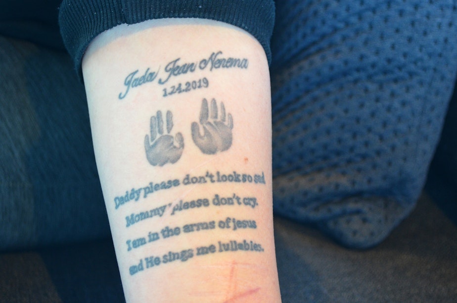caption: On Thursday, April 24, 2025, Sarah Nenema shows the tattoo she got for her stillborn daughter.