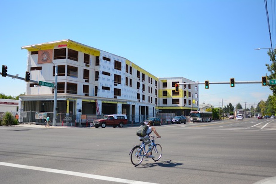 caption: <p>Proponents of the measure held a press conference at the construction site of the Jade/APANO Multicultural Space (JAMS) on SE 81st&nbsp;Avenue. It's a&nbsp;5,000-square-foot community center with&nbsp;solar panels, the kind of community project proponents say will be supported by the Portland Clean Energy Fund.</p>