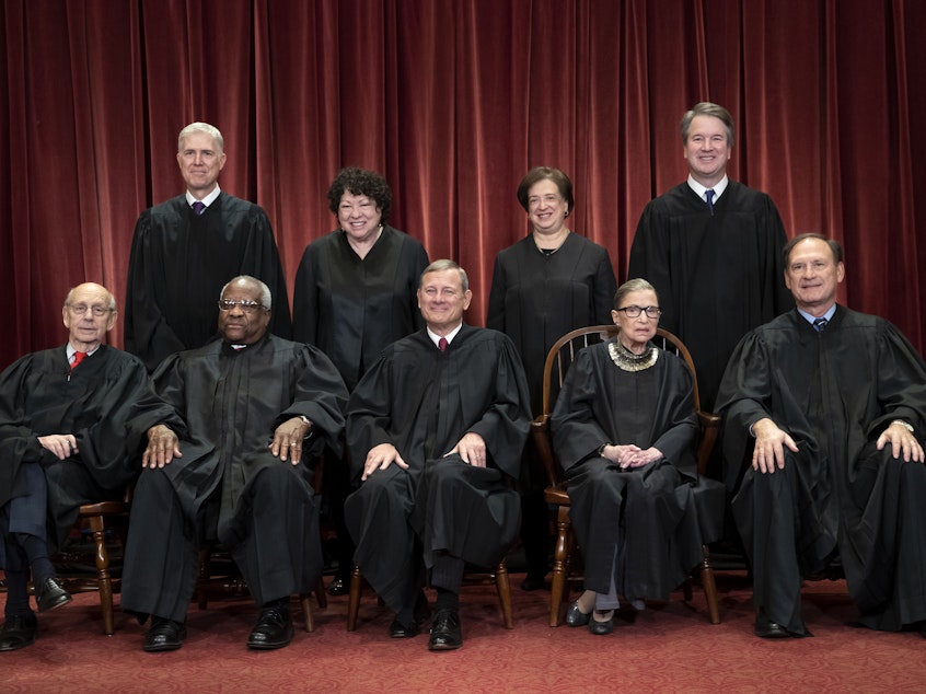 caption: The justices of the U.S. Supreme Court gather for a group portrait.