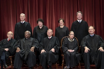 caption: The justices of the U.S. Supreme Court gather for a group portrait.