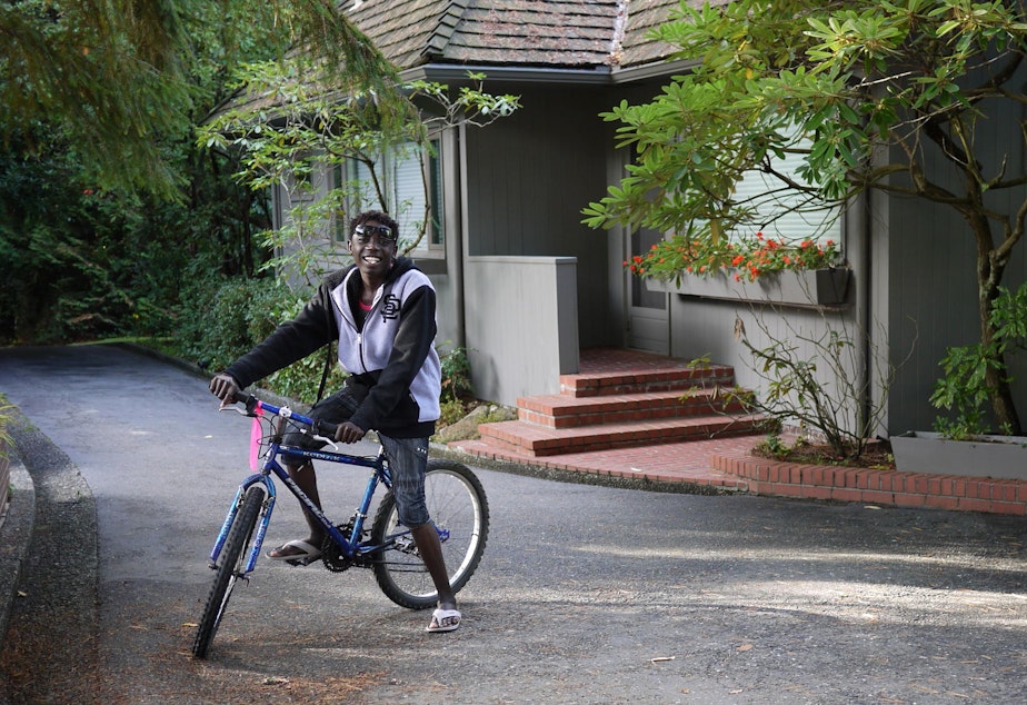 Mario, an 18-year-old refugee from Eritrea, outside his host home in Burien. Mario and his siblings each picked out a bike of their own, thanks to a donation to World Relief.