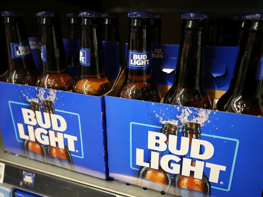 caption: Bud Light's parent company, Anheuser-Busch, says sales and profits dropped in the U.S. between April and June.