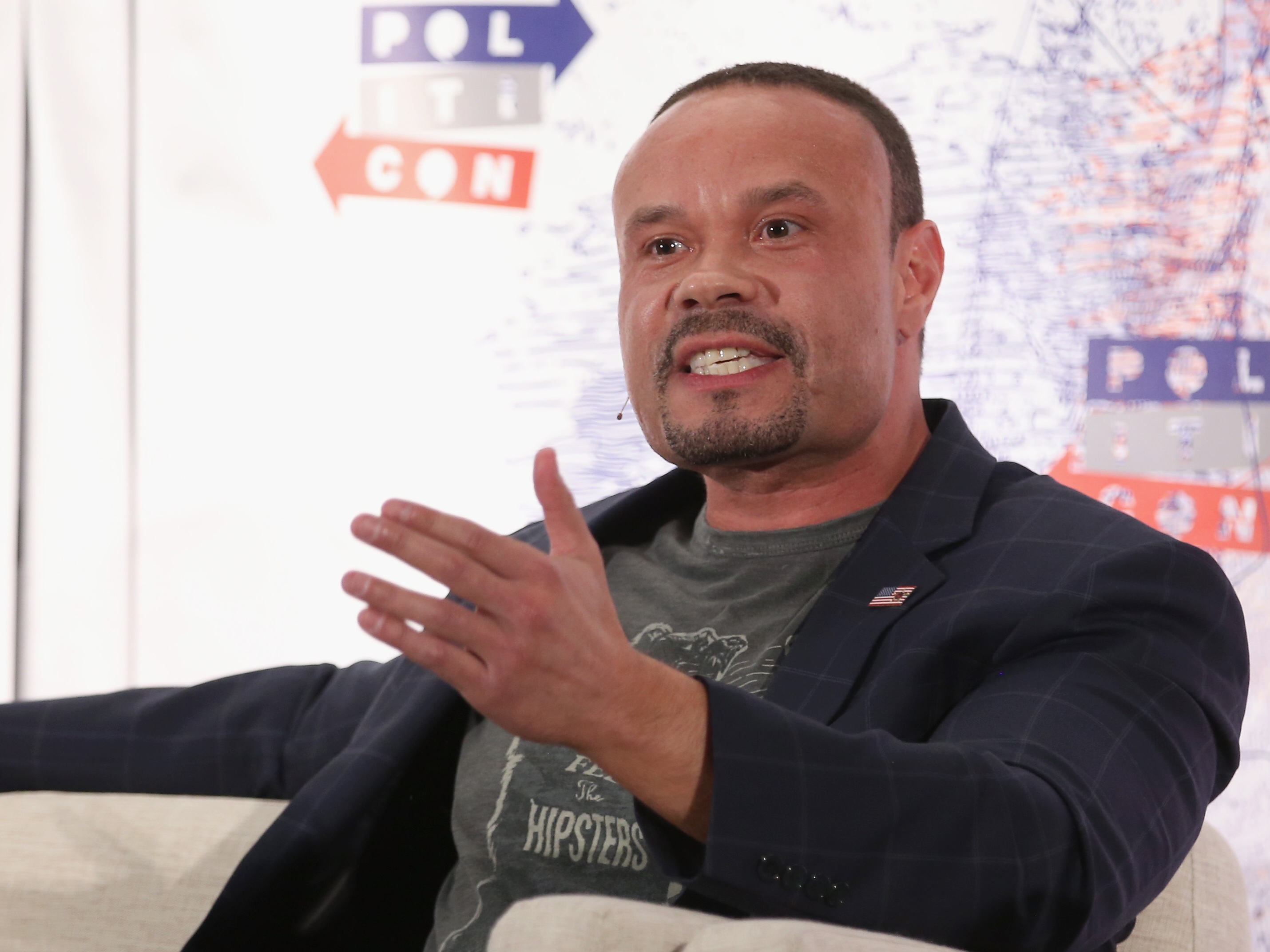 caption: Dan Bongino speaks onstage during Politicon 2018 at Los Angeles Convention Center.